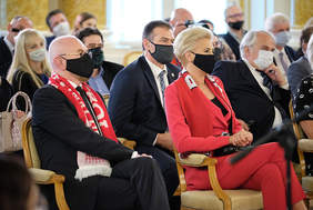 Pokaż zdjęcie: W pierwszym szeregu publiczności siedzi Pierwsza Dama RP. W tle inni uczestnicy uroczystości- kilkadziesiąt osób