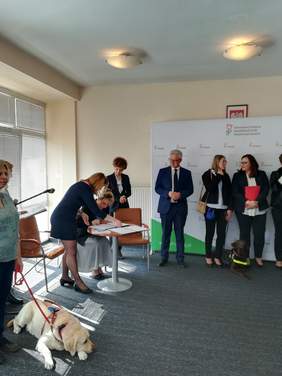 Pokaż zdjęcie: Osoba składa podpis pod umową